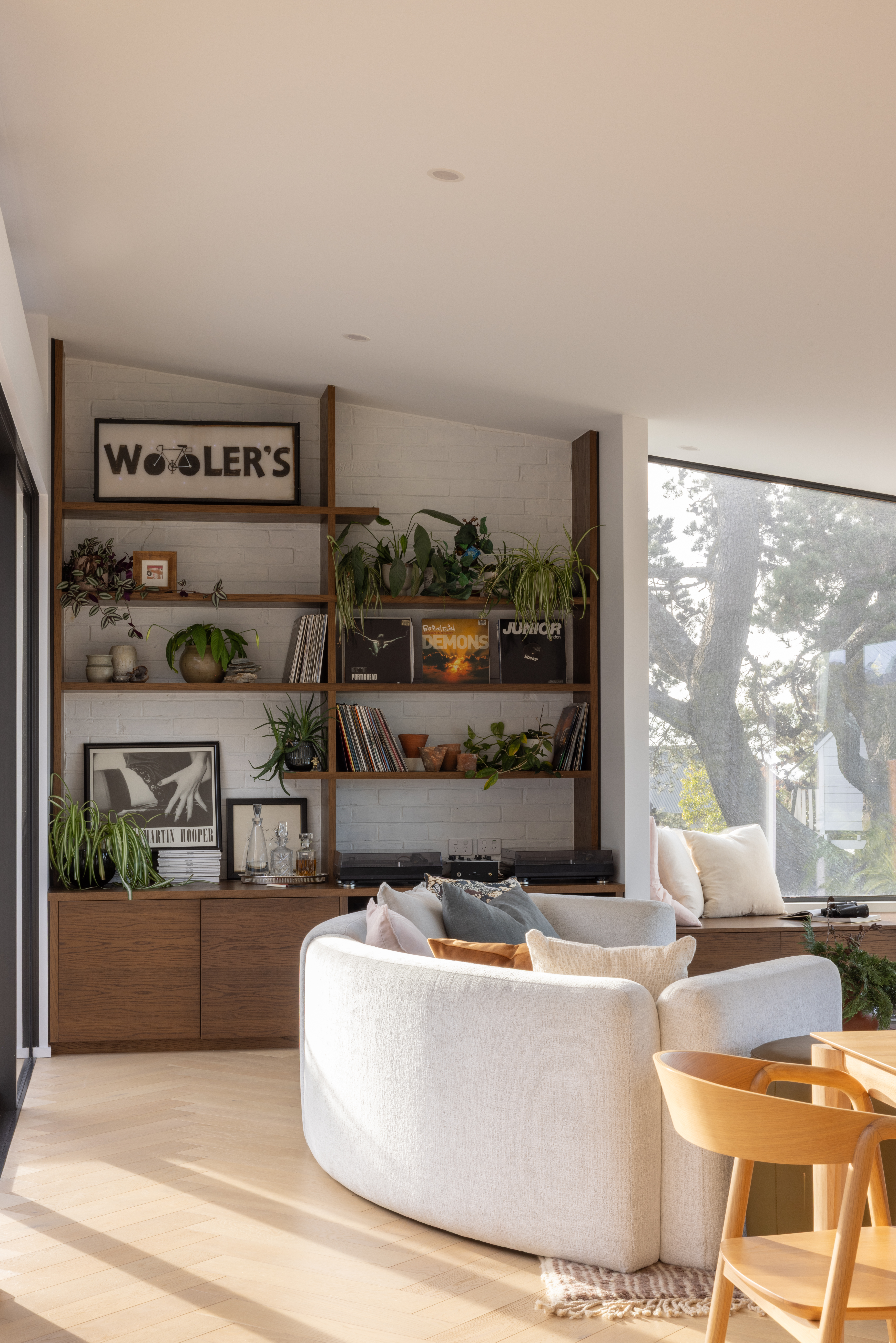 Main living area with seating and oak shelving. 