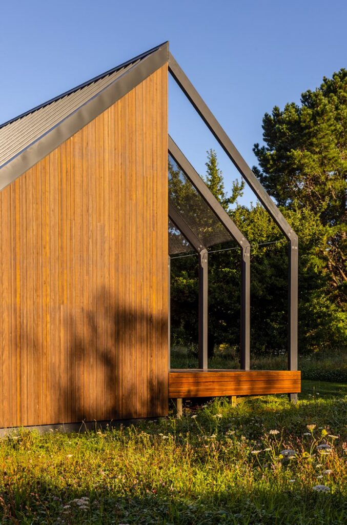 The Abodo timber siding with a gabled glass roof over a veranda.