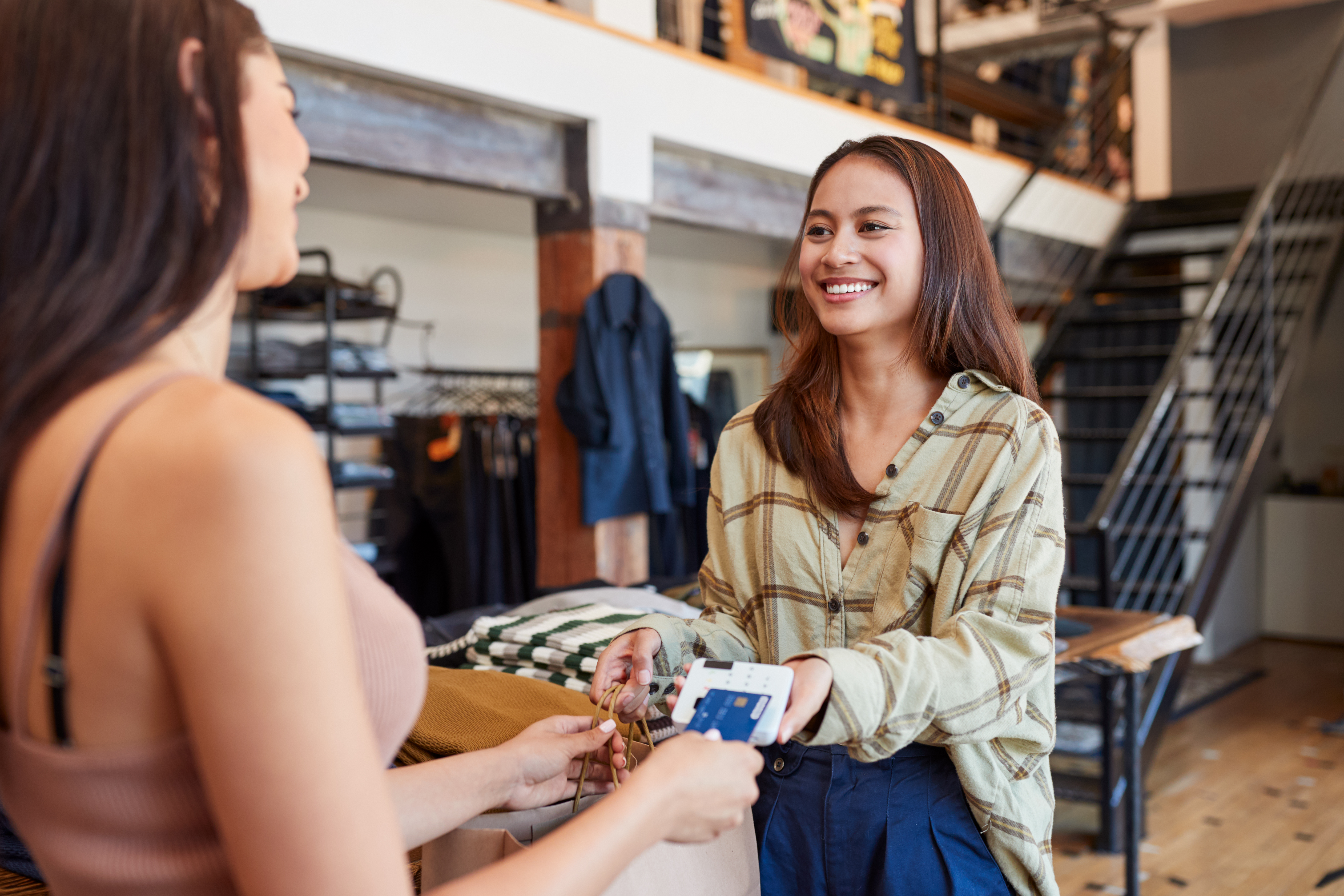 Female uni student working in a retail environment.