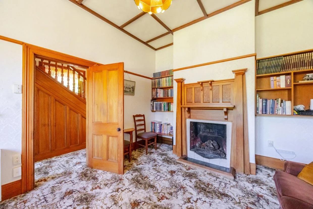 The house retains original craftsmanship including detailed fireplace surrounds.