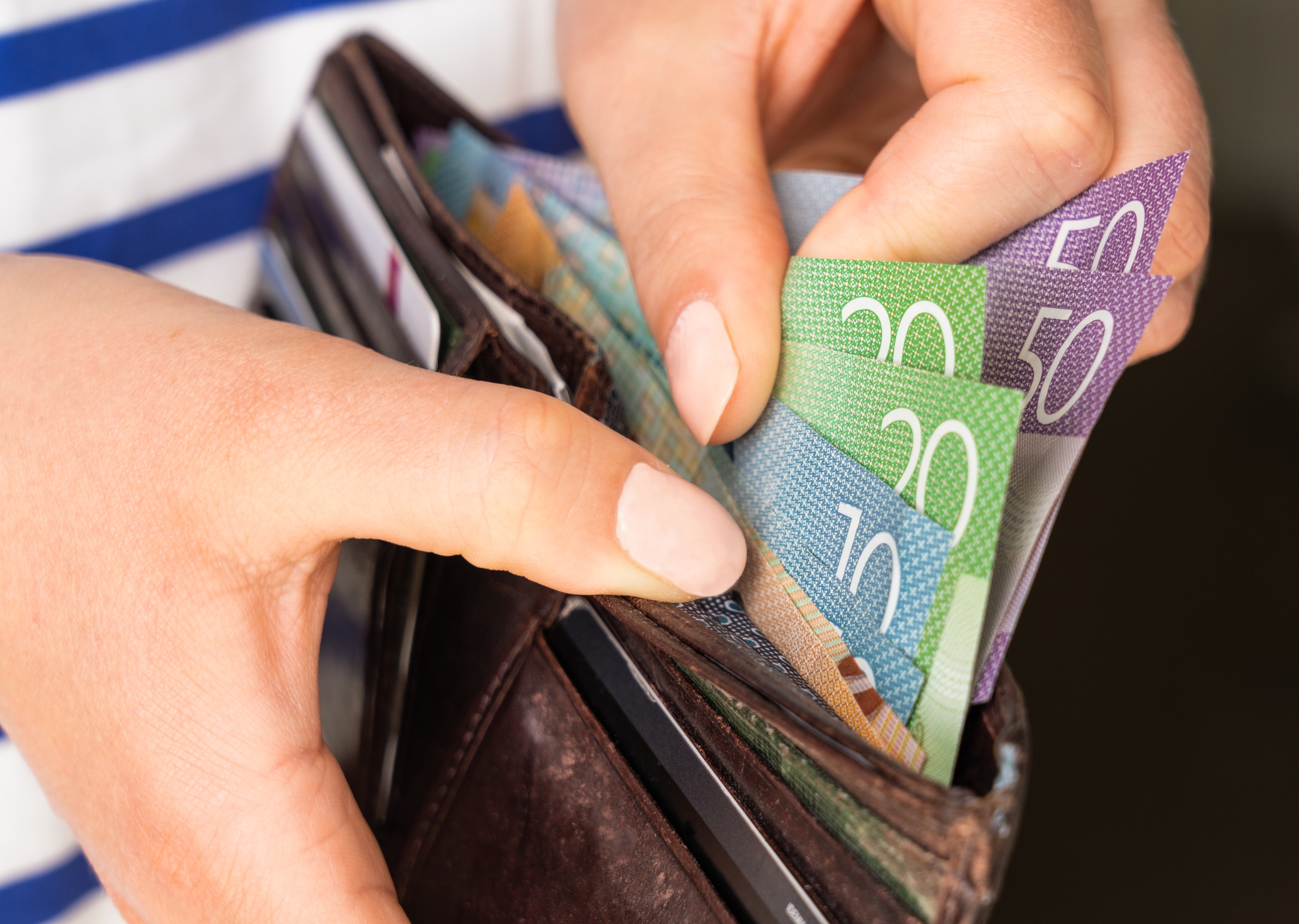 photo of a wallet with a lot of cash