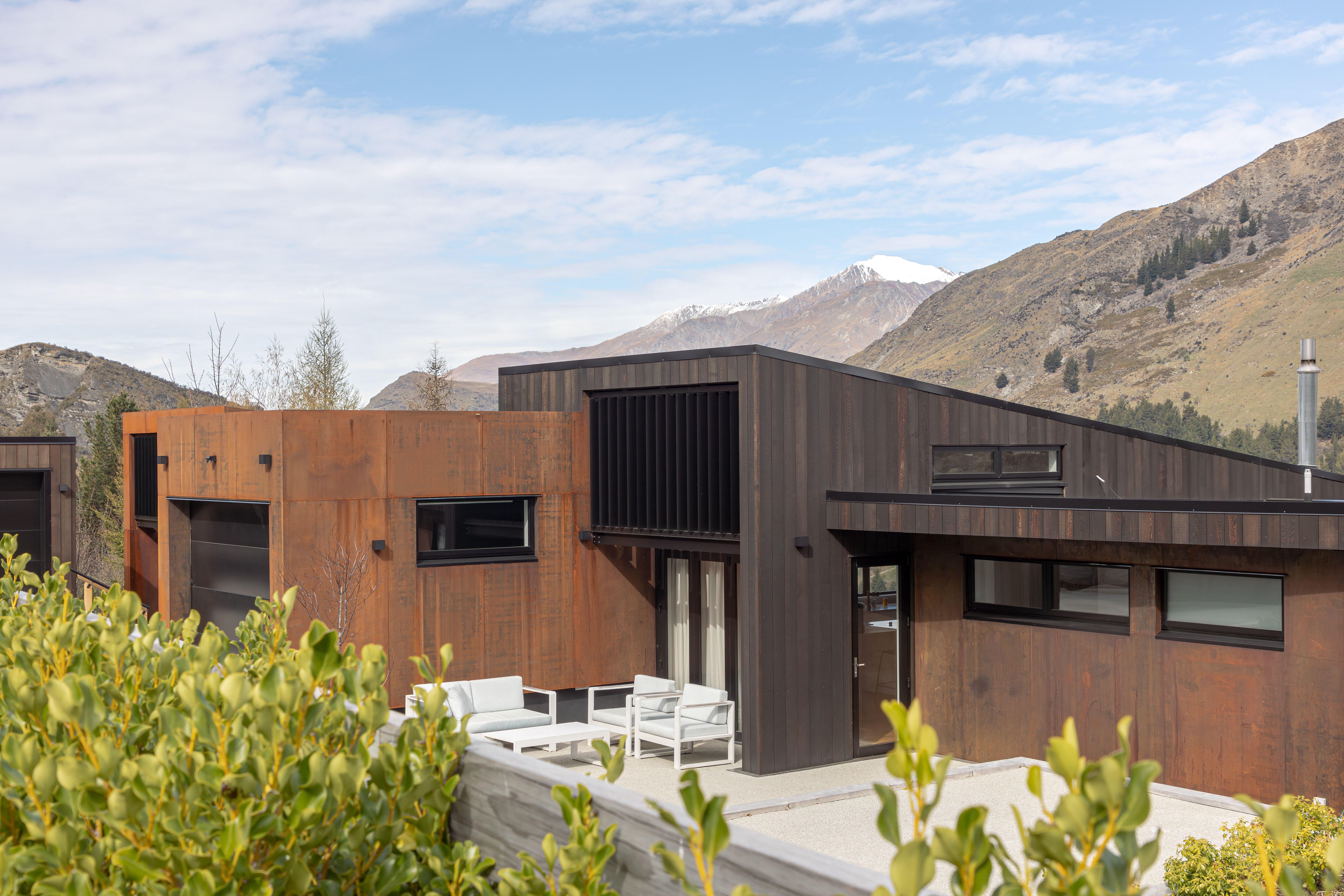 This Arthurs Point, Queenstown home uses corten steel and vertical timber cladding ensuring the house blends into the natural environment. Image by John Williams