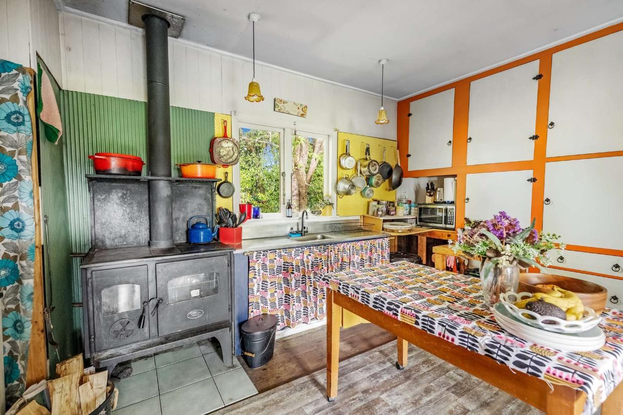 Kitchen carries a rustic, lived- in charm. 