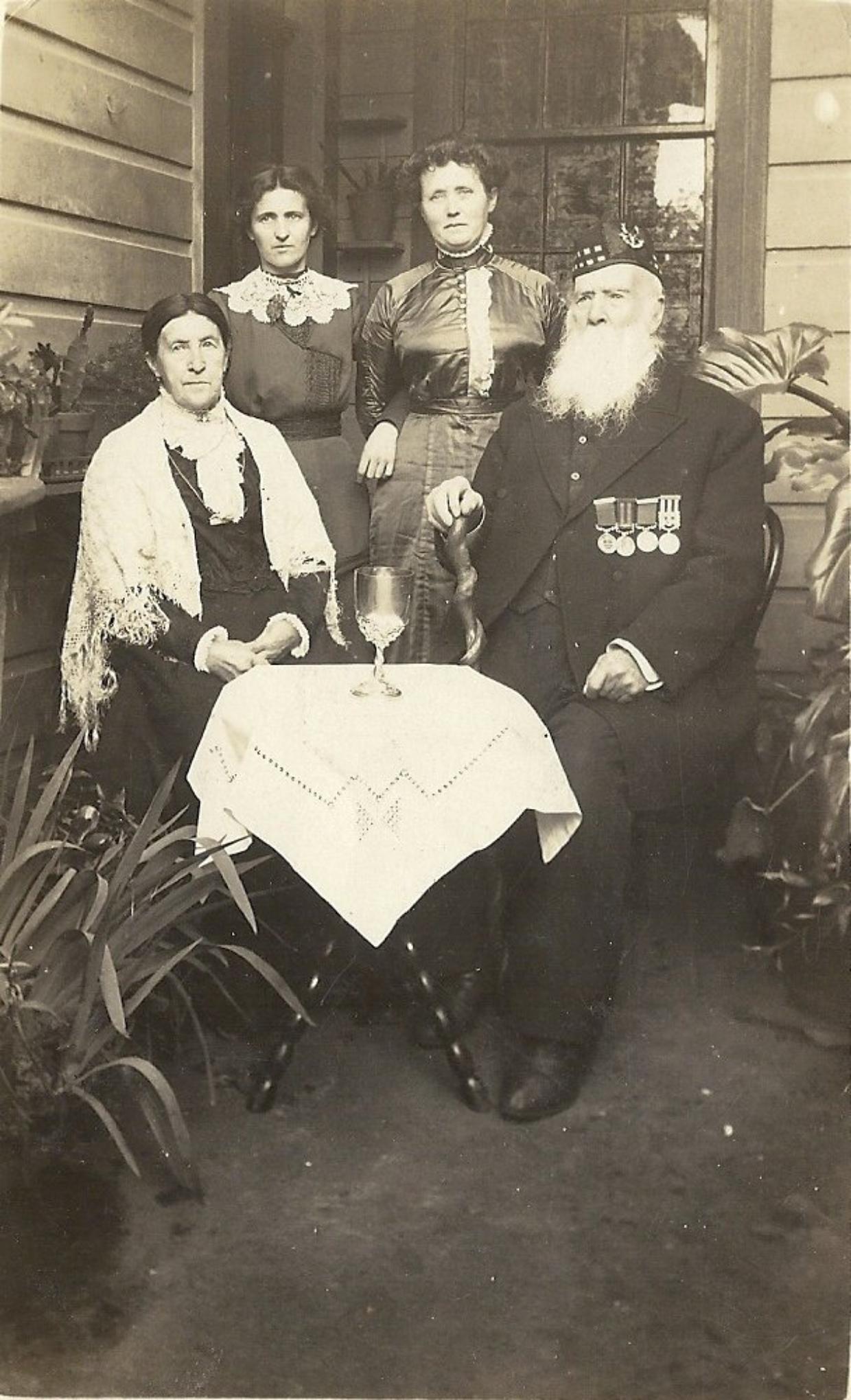 Flashback: Samuel Atkins with family outside the Ettrick Cottage at Austin St, Mt Victoria. Atkins was a local identity in Wellington.