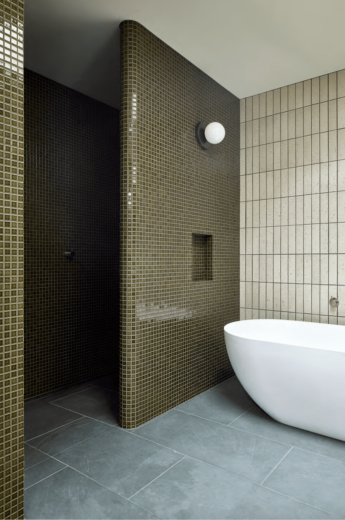 Bathroom by Rogan Nash Architects, featuring floor-to-ceiling tiles in various colors and formats, complemented by slate floor tiles. Photo: Simon Wilson.