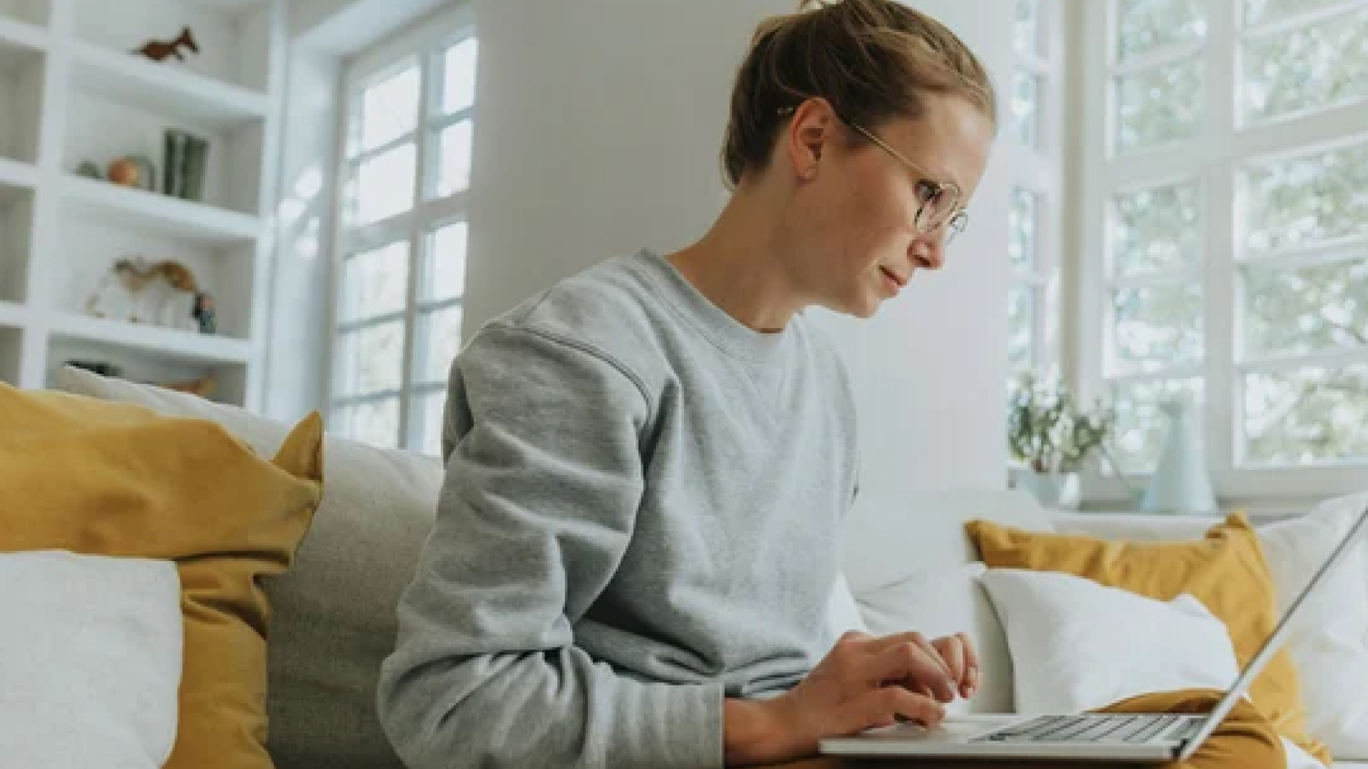 Female recruiter writing a job ad on her laptop