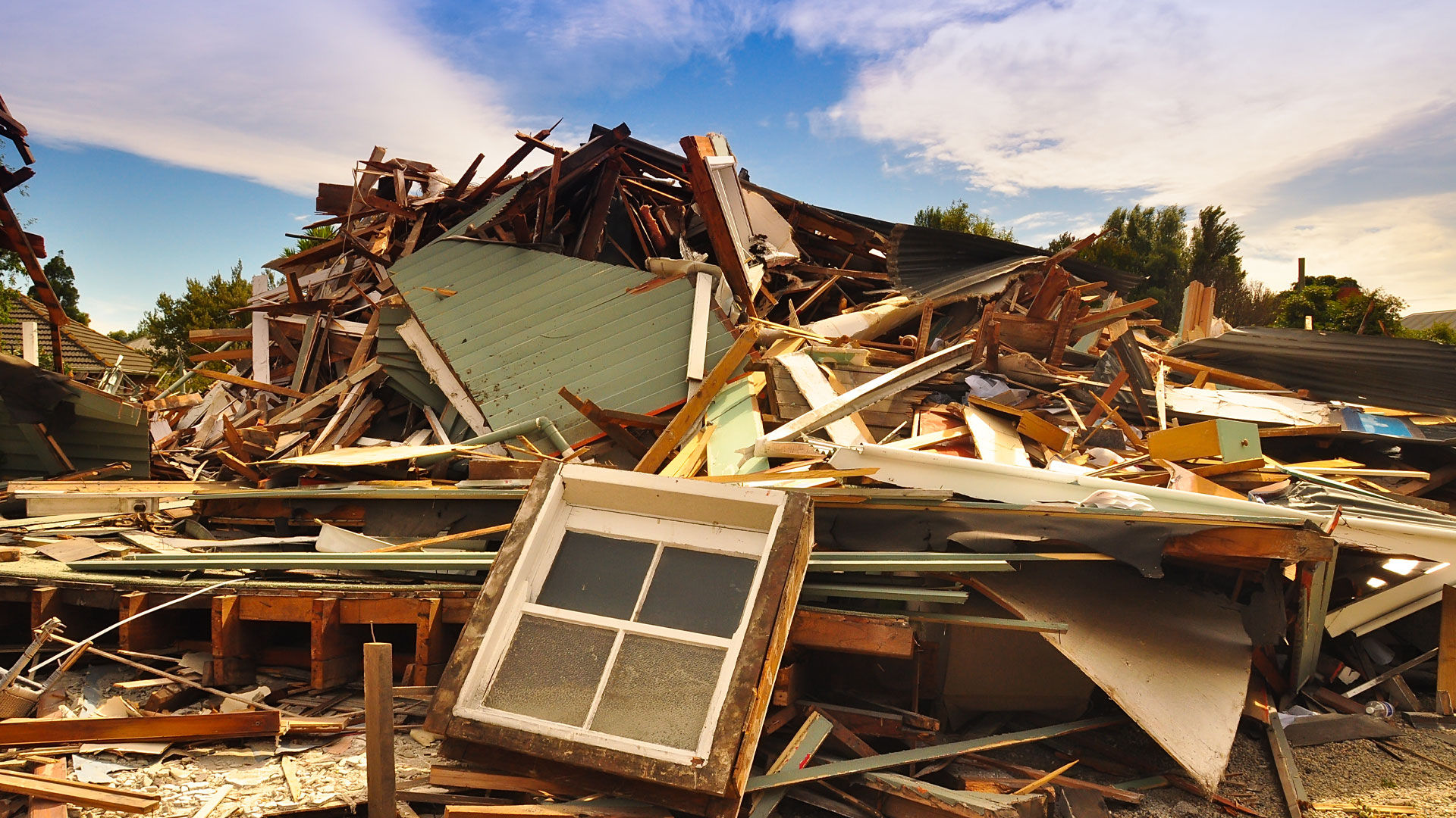 A pile of rubble from a destroyed house in NZ following a natural disaster.