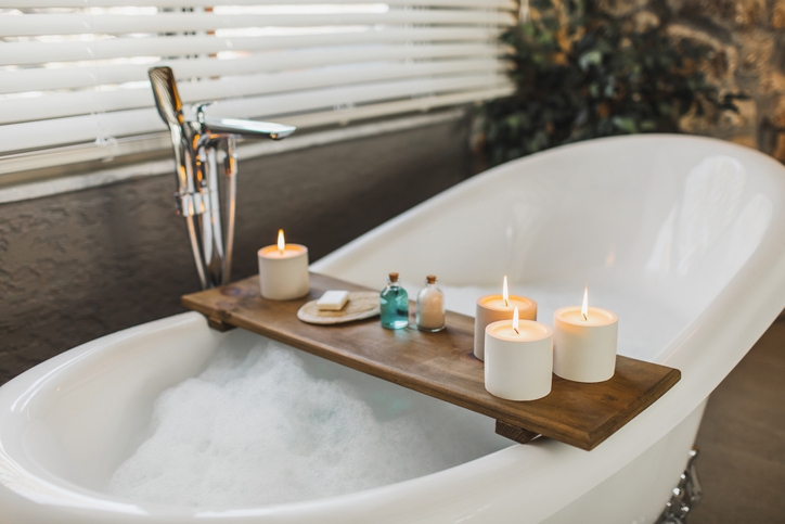 Relax in a bath filled with bubbles, surrounded by candles.