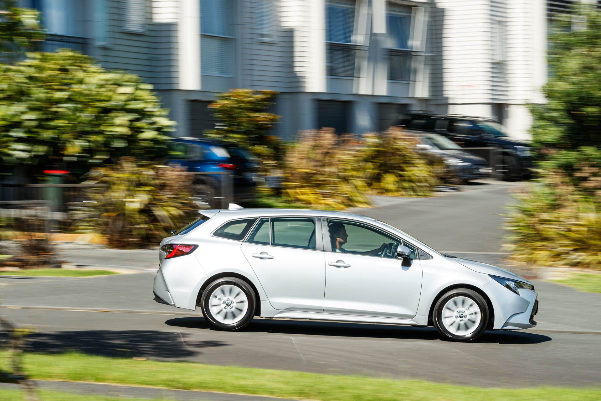 Silver Toyota Corolla GX Hybrid driving side view