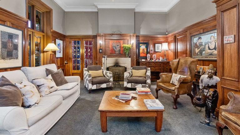 The panelled living room has created a perfect backdrop for the owners’ extensive art collection. Photo: Columbs & Co