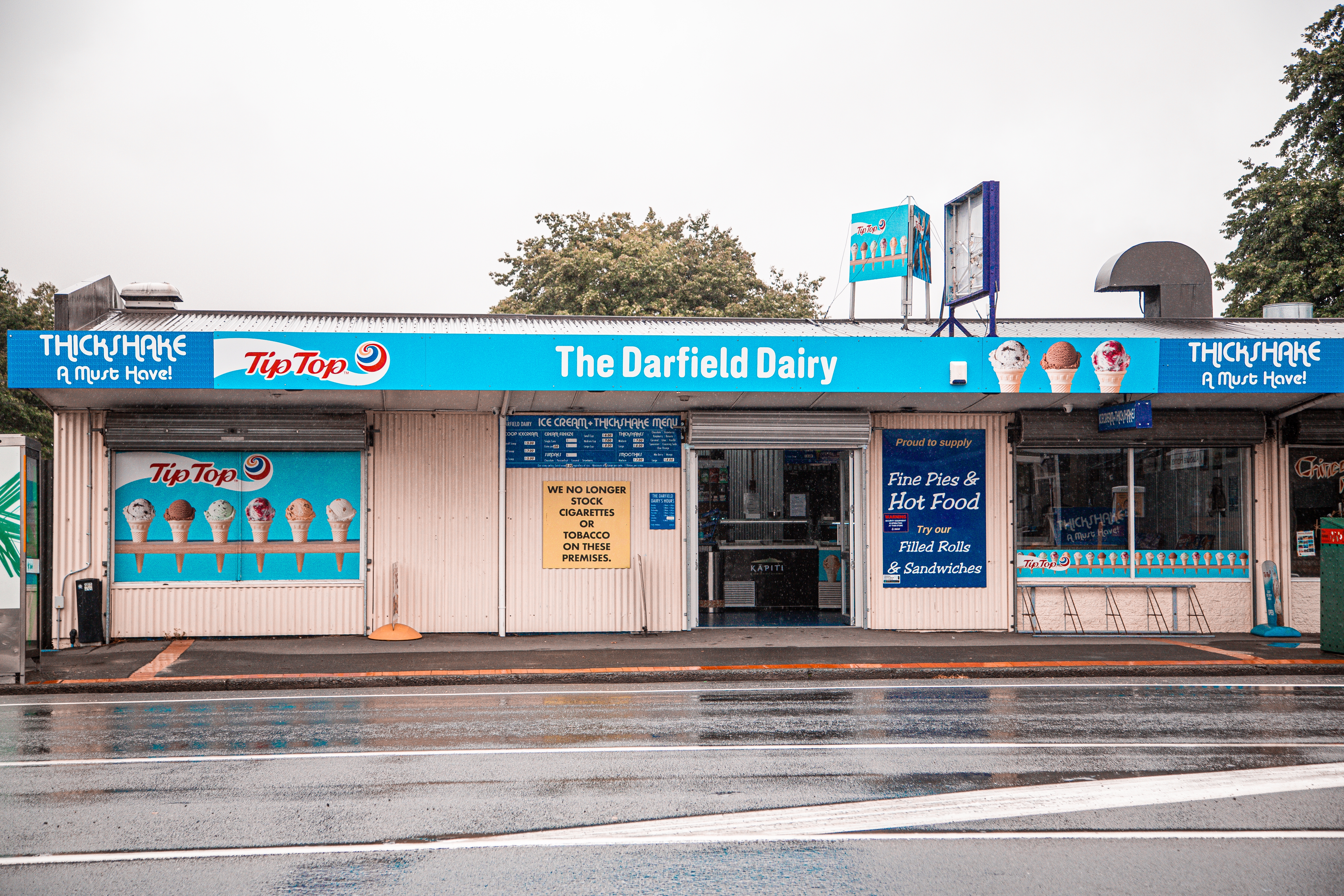 Blue and white shop front with a header that says Darfield Dairy. 