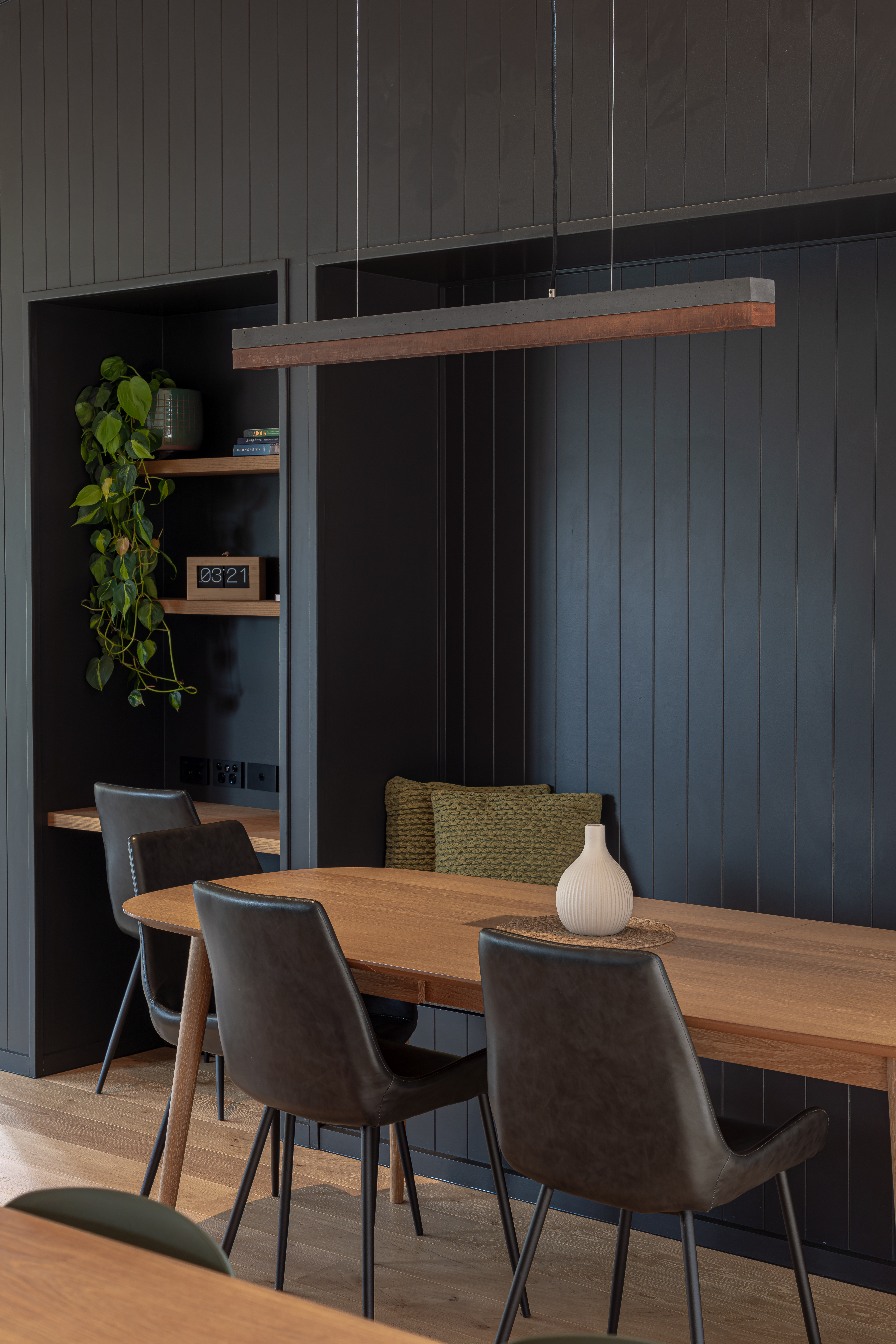 This dining room in a home designed by Koia Architects combines dark tones with the tactility of timber to create an inviting space of rich layers. Image: John Williams.