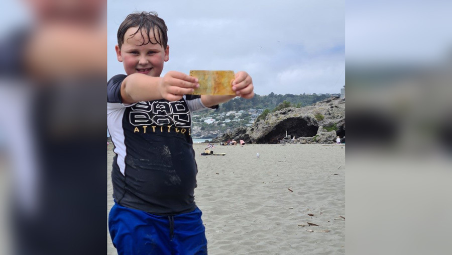 Boy with $5 note