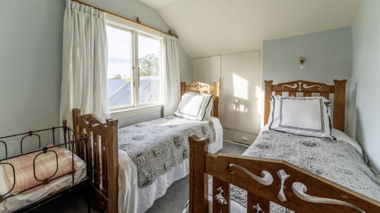 Bedrooms have also been furnished in keeping with the era. Photo: Harcourts
