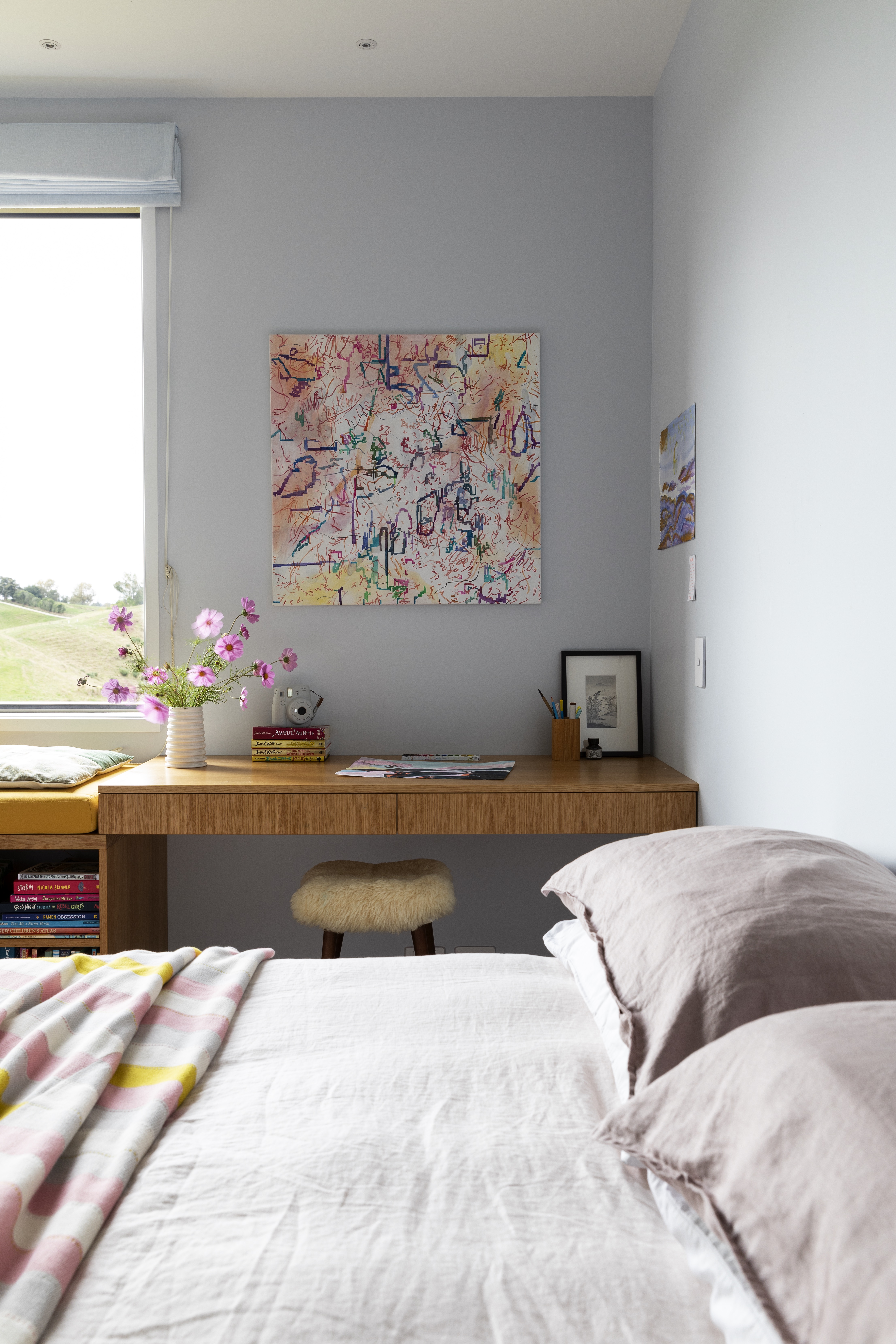  For Georgia’s room, the team designed a window seat below a large sliding window to give her wide-open views to the northwest. It connects to a desk, above which is an artwork by Sue Novell.