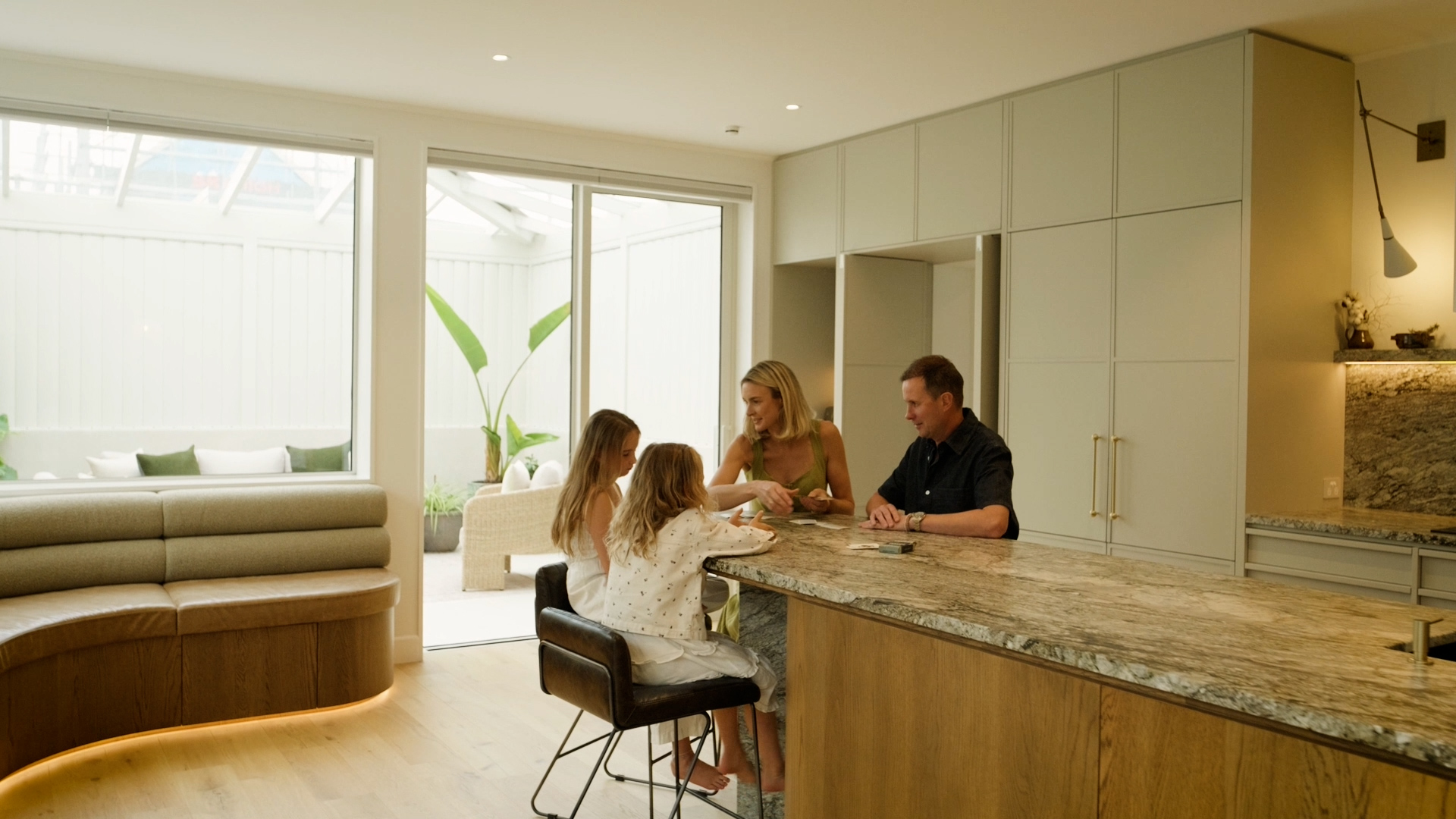The family playing cards in the kitchen.