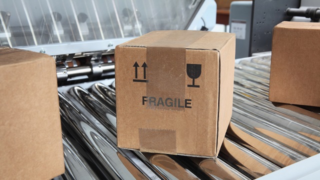  Fragile cargo box on conveyer belt.