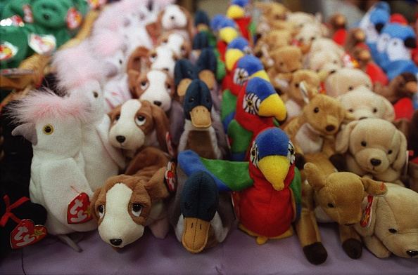 Assorted colorful Beanie Babies plush toys arranged neatly in a display, representing a popular 90s collectible craze.
