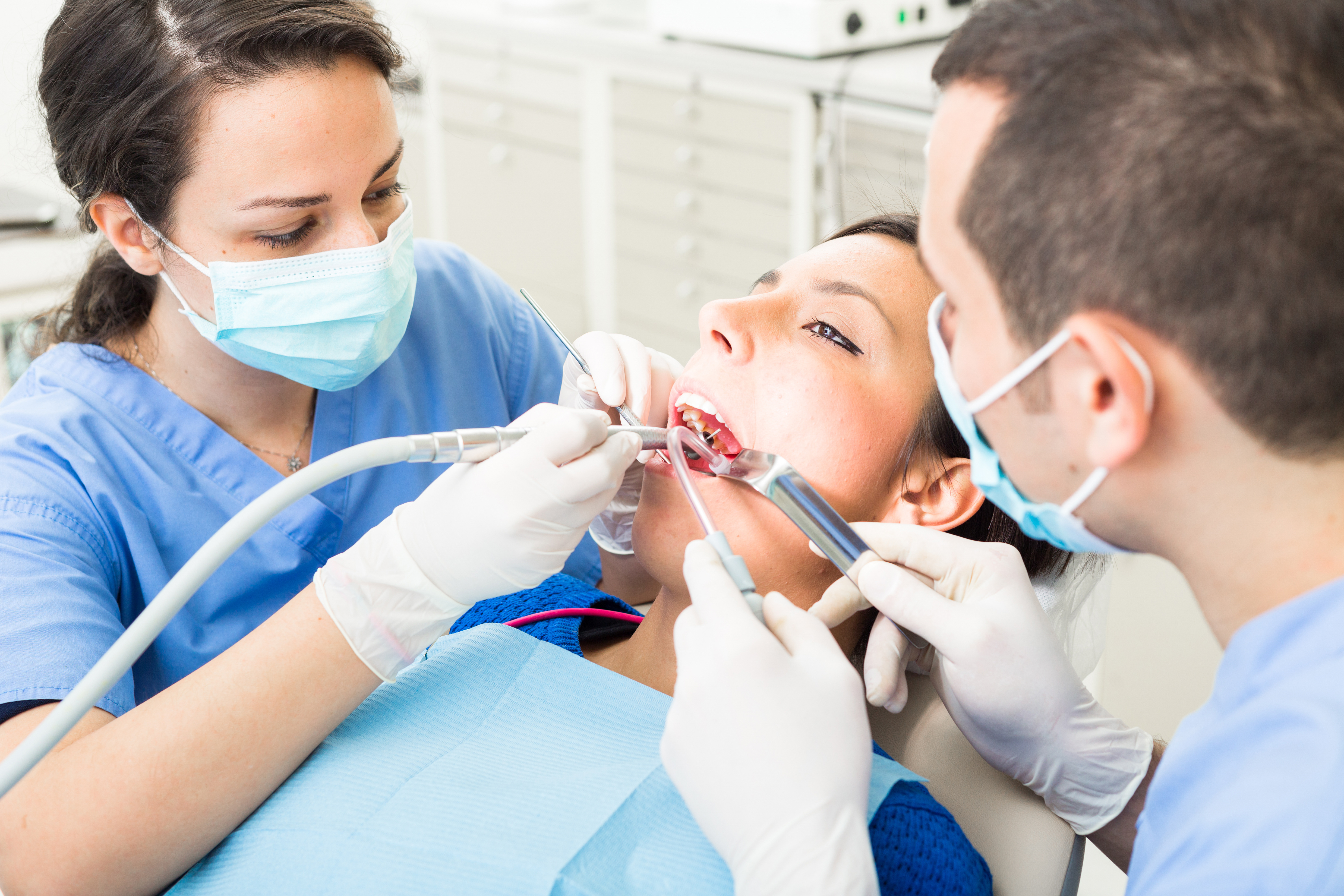 Dentist and dental assistant treating a patient