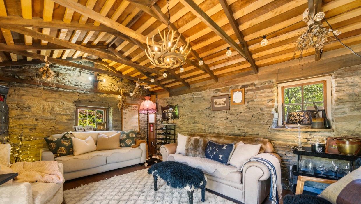 Character features include schist and plaster walls and an exposed wooden ‘cathedral’ ceiling.