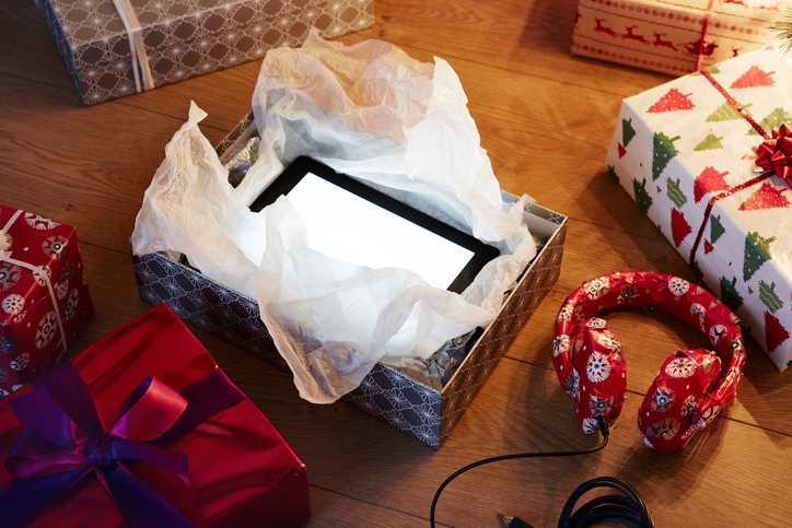 An Ipad and headphones wrapped in Christmas paper.