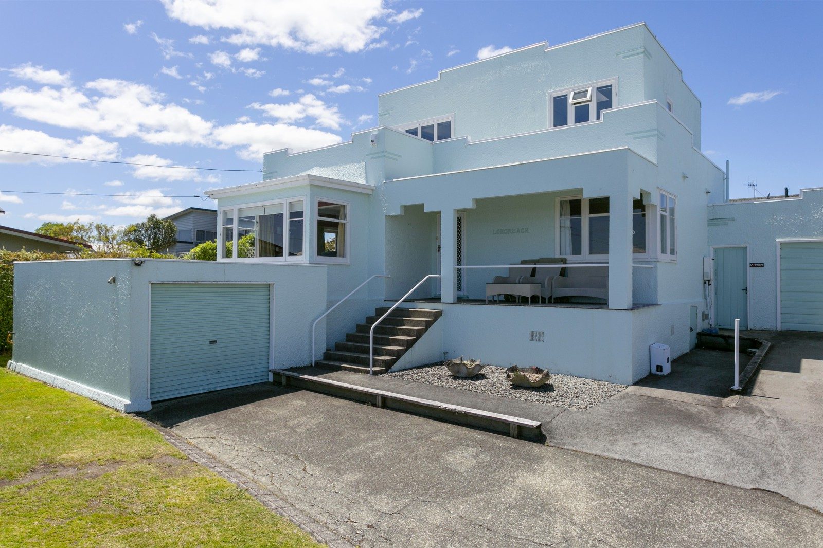 Street view of 12 Mere Road, Town Centre, Taupō. A home painted in mint green.