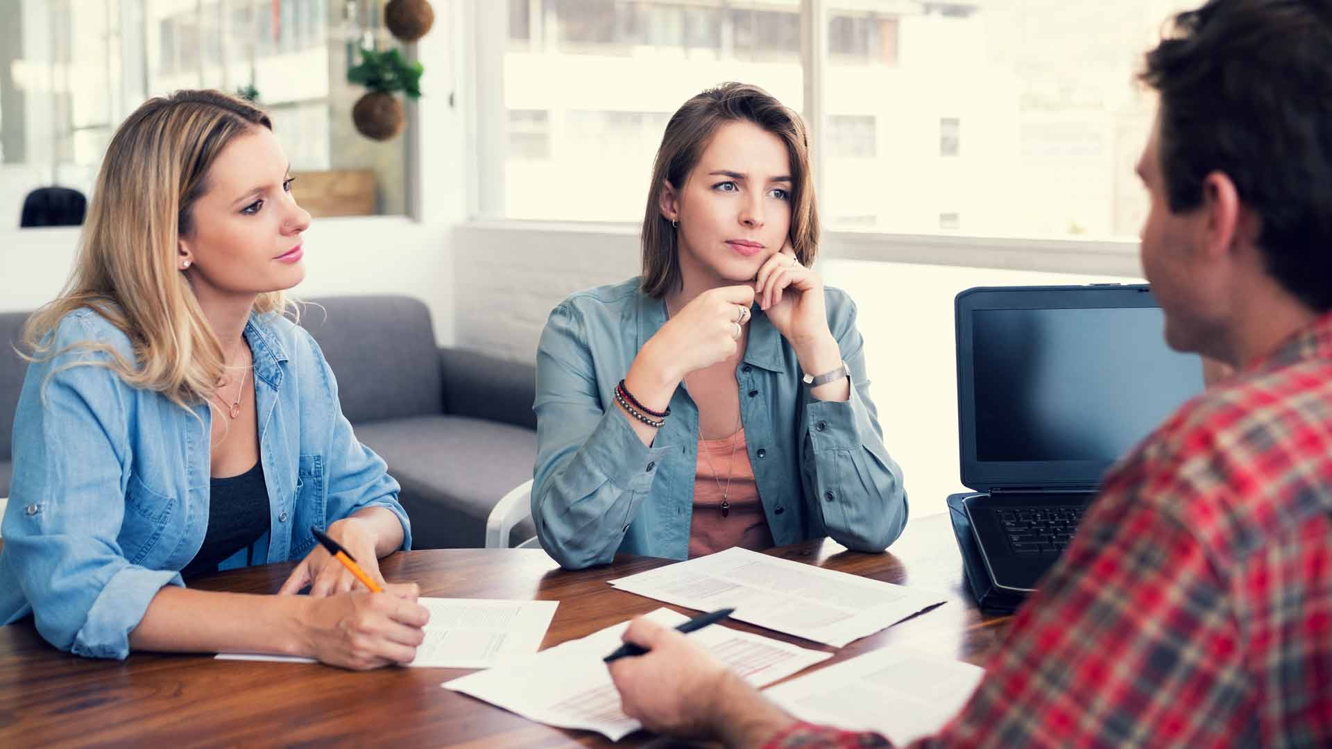 Couple interviewing a prospective real estate agent.