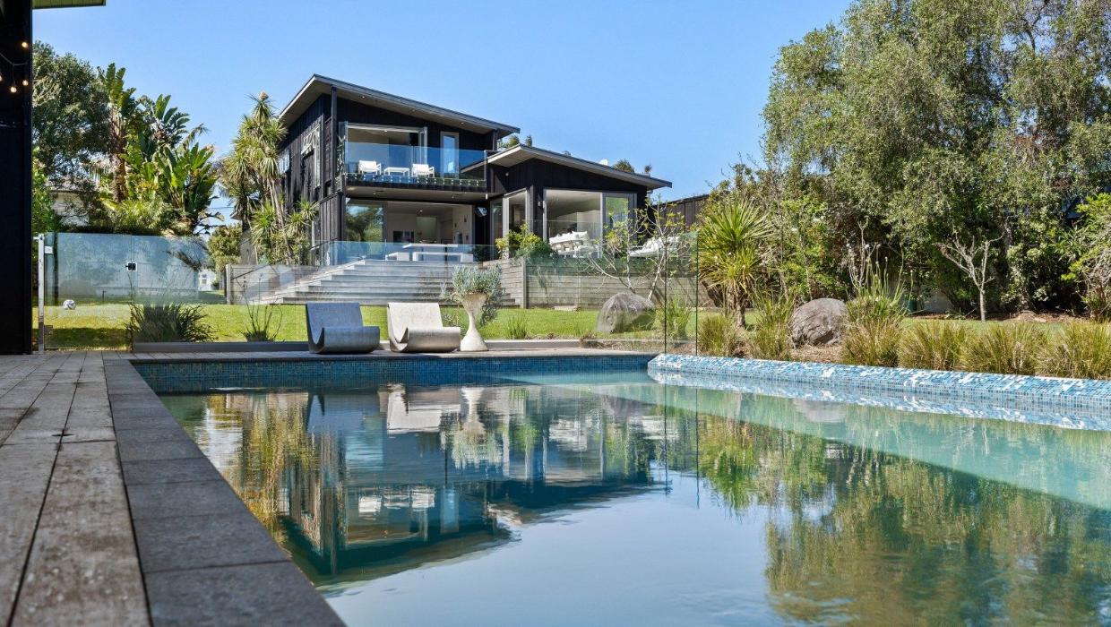 Originally, the owners of this beautiful waterfront property in Point Chevalier were going to build an extra house on this land, but decided they would rather give their children space to play. Photo: NZ Sotheby's
