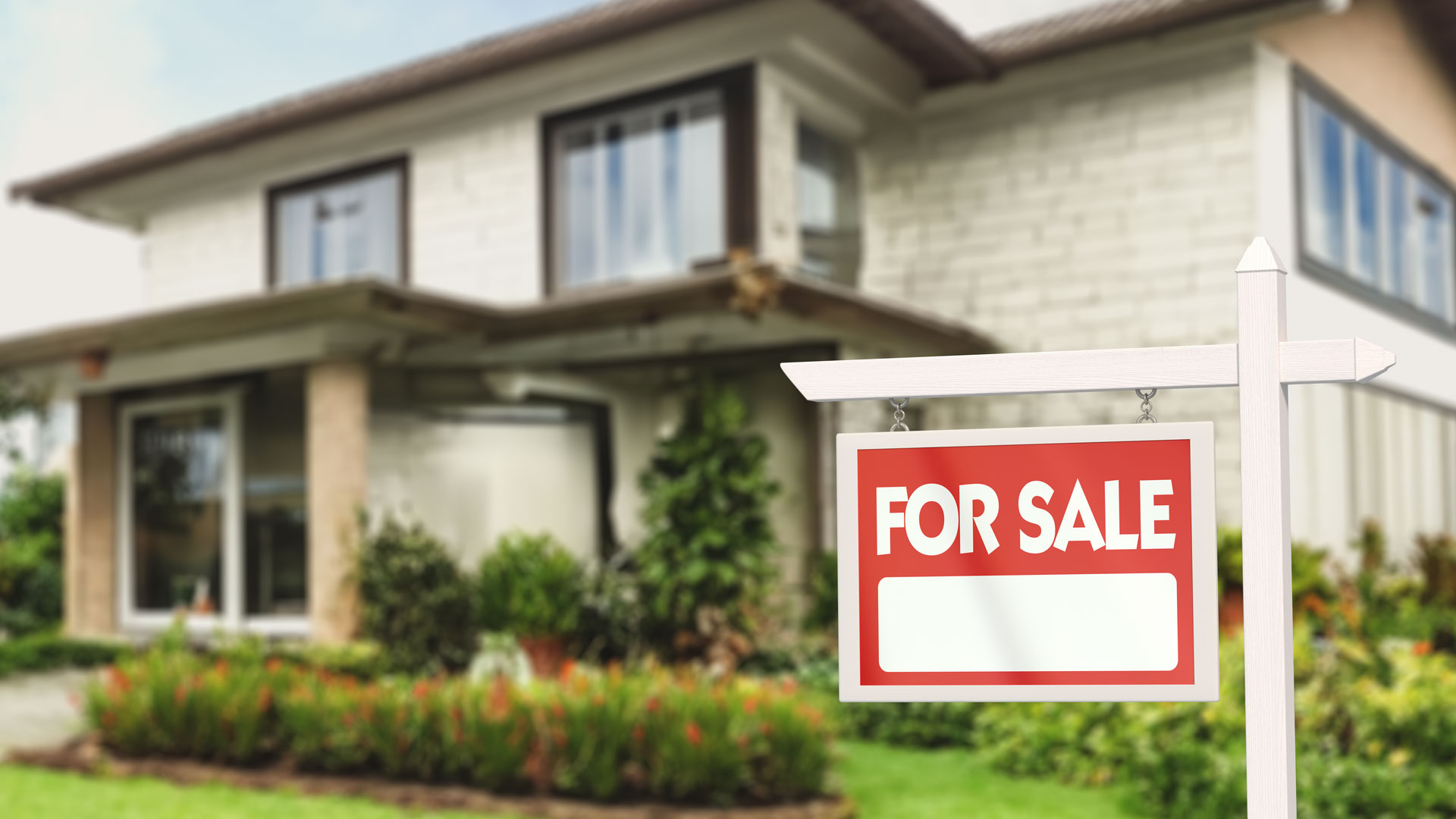 A home for sale in NZ with a sale outside it.