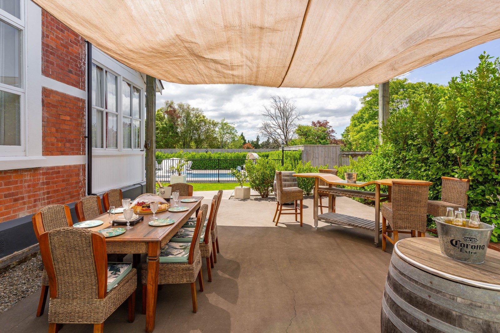 Outdoor area at 193 East Street, Greytown. Outdoor table, BBQ and pool in the background.