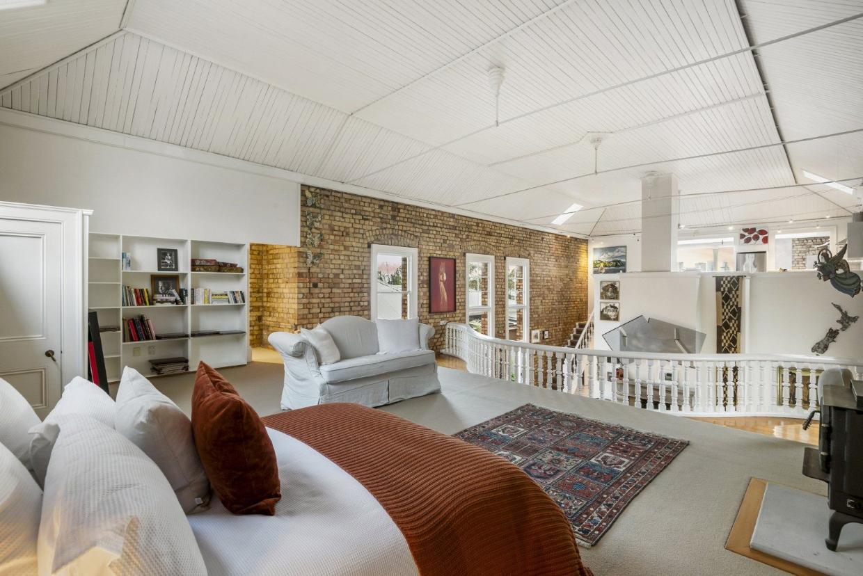 When the owner moved in, this space was divided into separate rooms. She has opened it all up again to create a guest room. 