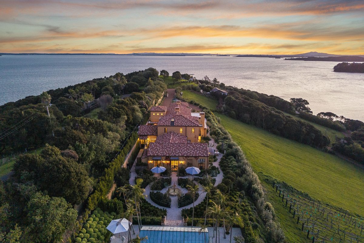 Luxury Mediterranean-style mansion on Waiheke Island, Te Whau Estate, among the most expensive houses in NZ, with terracotta roofs, landscaped gardens, and sweeping views over the Hauraki Gulf.