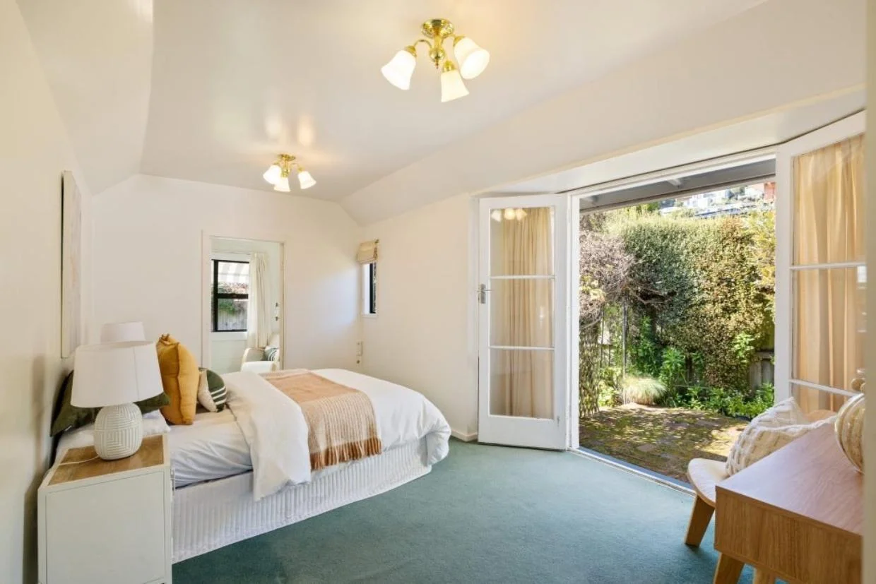Sumner cottage bedroom with French doors to the garden.