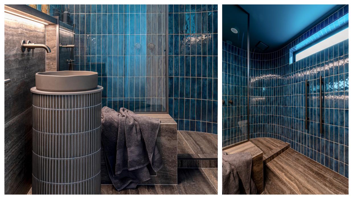 The curved forms of the standalone basin and shower wall help to soften the look