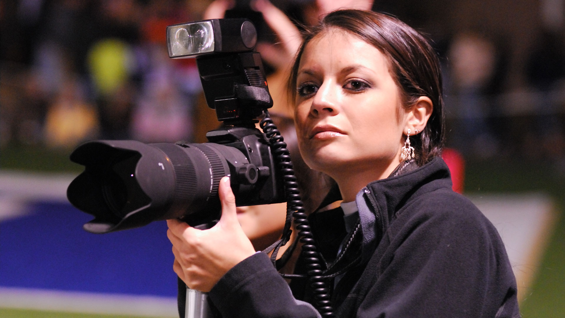 Sports photographer working at a big match.
