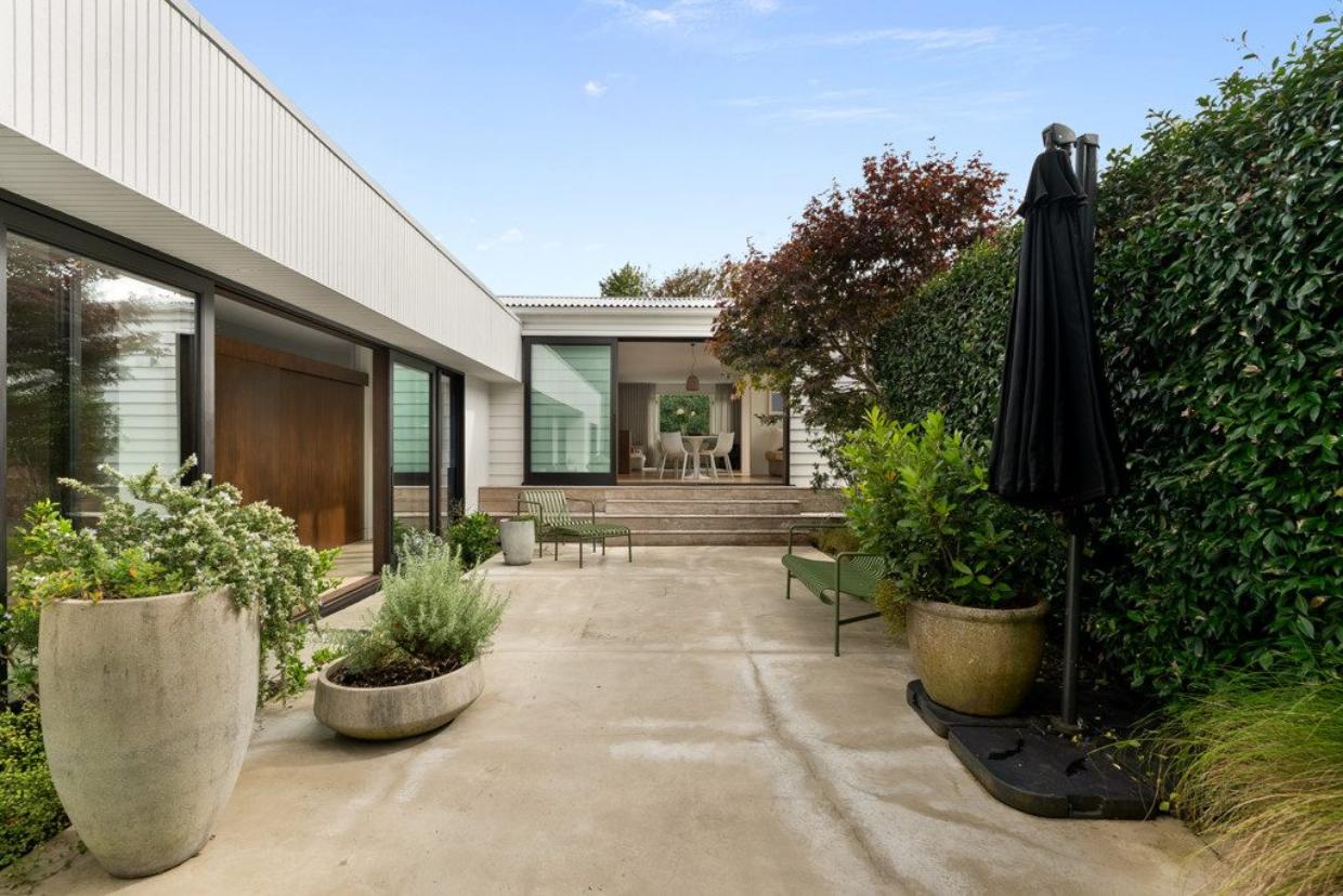 Cosy courtyard that has seating and sunlight 