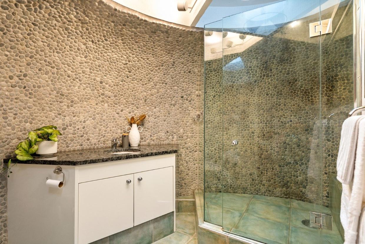 The home has so many unique, quirky features, such as this pebbled shower room.