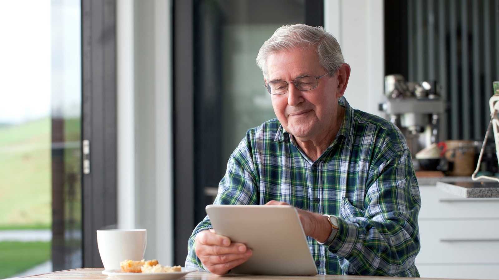 Old man looking at tablet. 