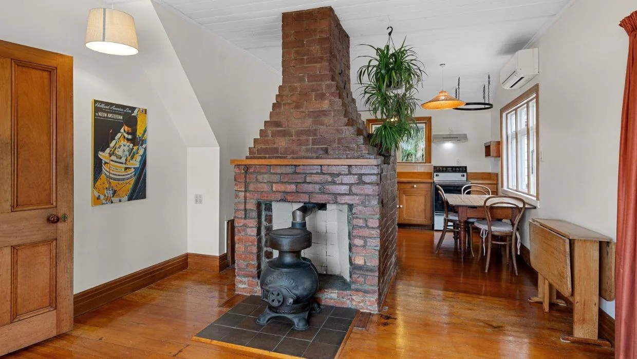 The home has kauri floorboards and exposed brickwork.