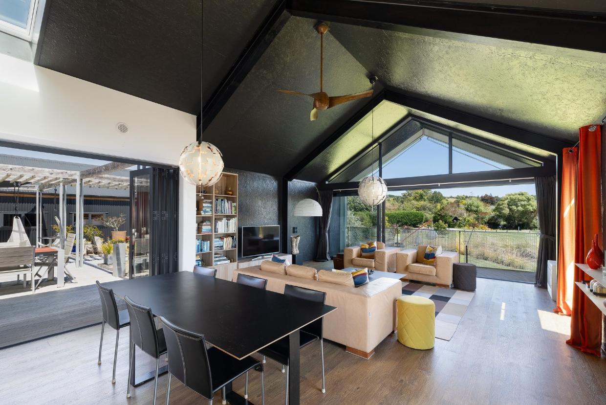 The living area flows out to the balcony at front, and a large outdoor living area to the left. 