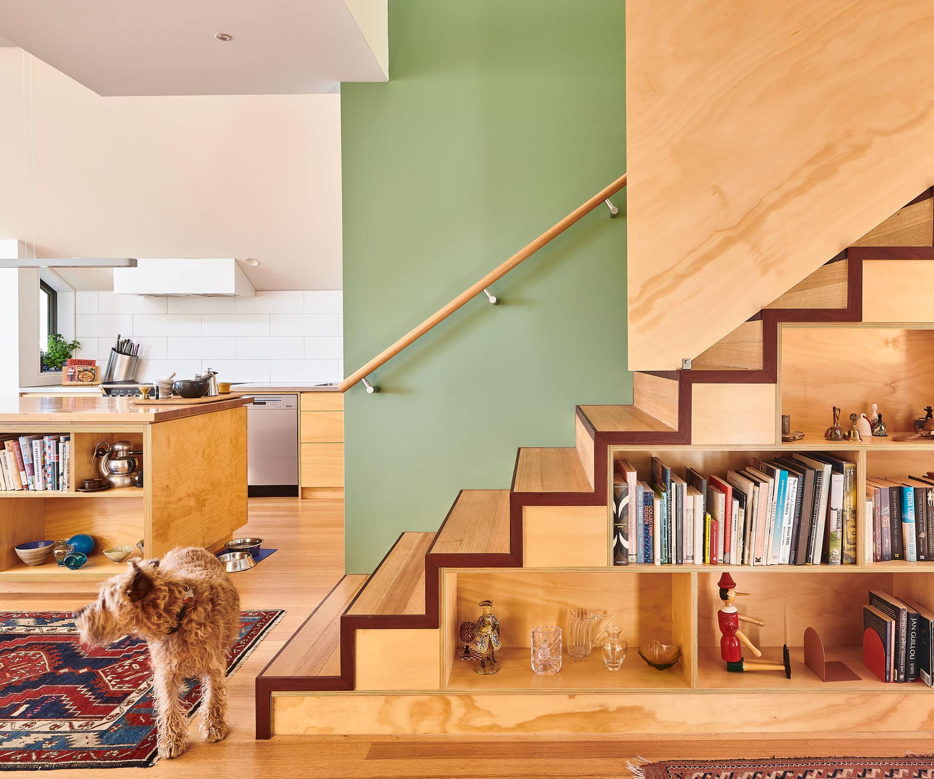 Wooden stairs with built-in wooden shelves underneath, providing a practical and stylish storage solution for the space.