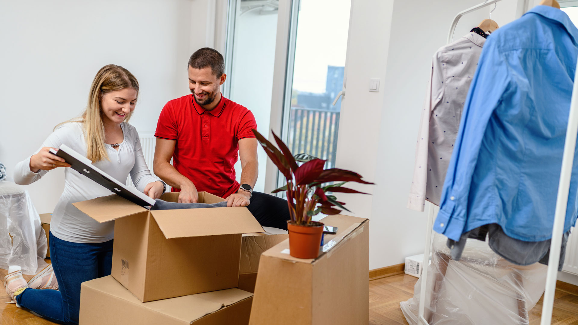 First home buyers unpacking a box in their new home.