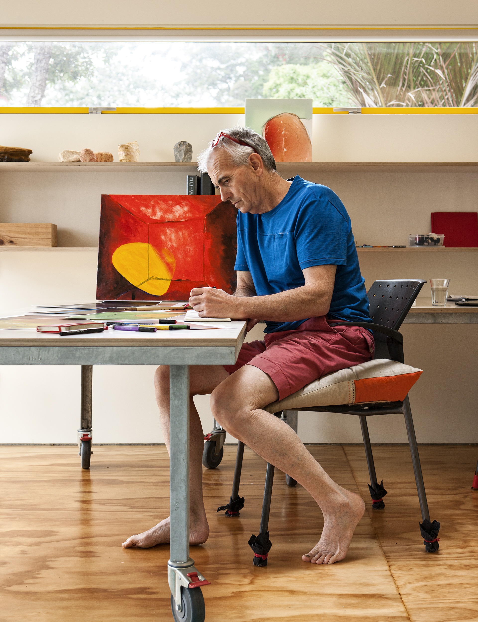 A man sitting and painting