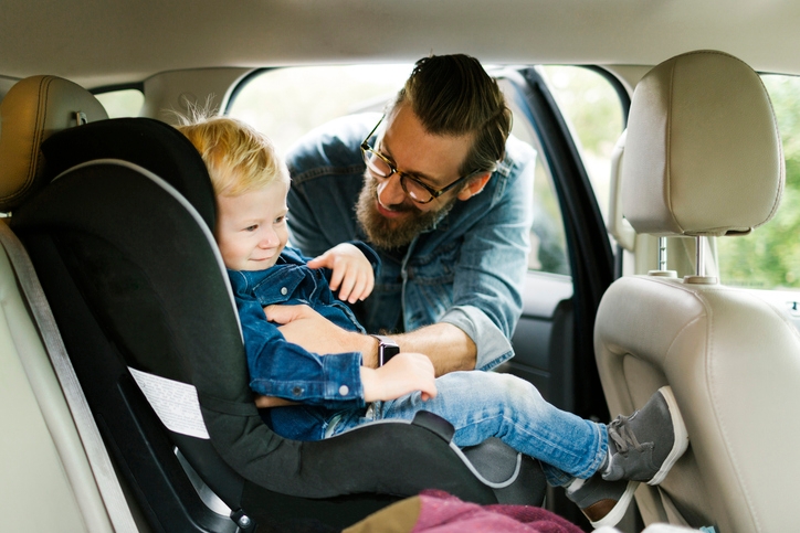 child getting put in car seat