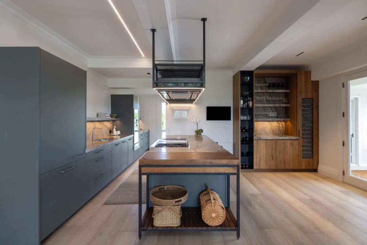 The kitchen features new handcrafted European cabinetry, and there is a wine bar to match. 