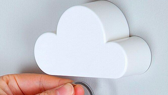Magnetic key holder in the shape of a cloud secured to a wall