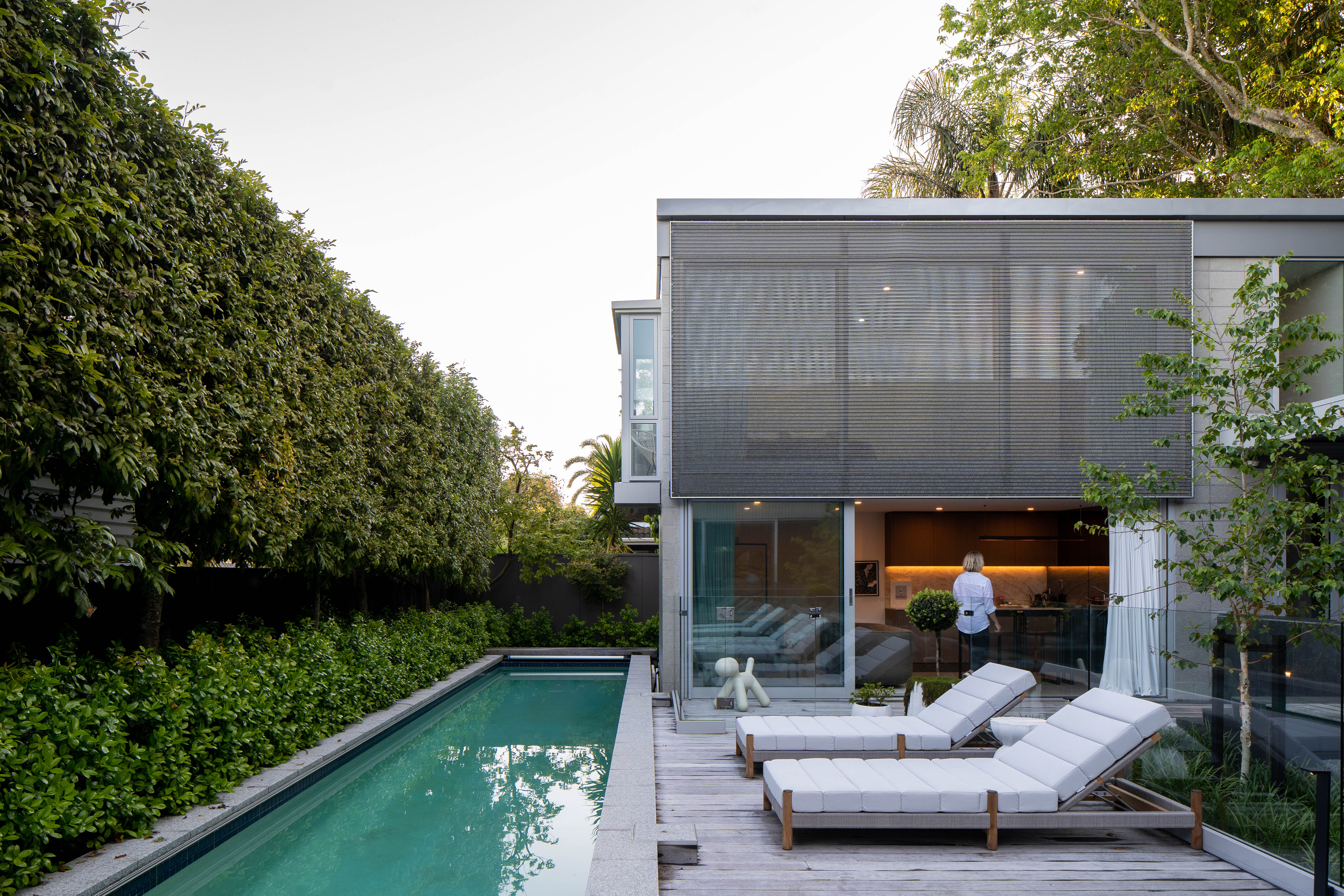 This pool house, designed by Johnston Architects and Bespoke Interior Design was added to a mid century home in Remuera, its design taking cues from the original material palette. Image: Paul Brandon