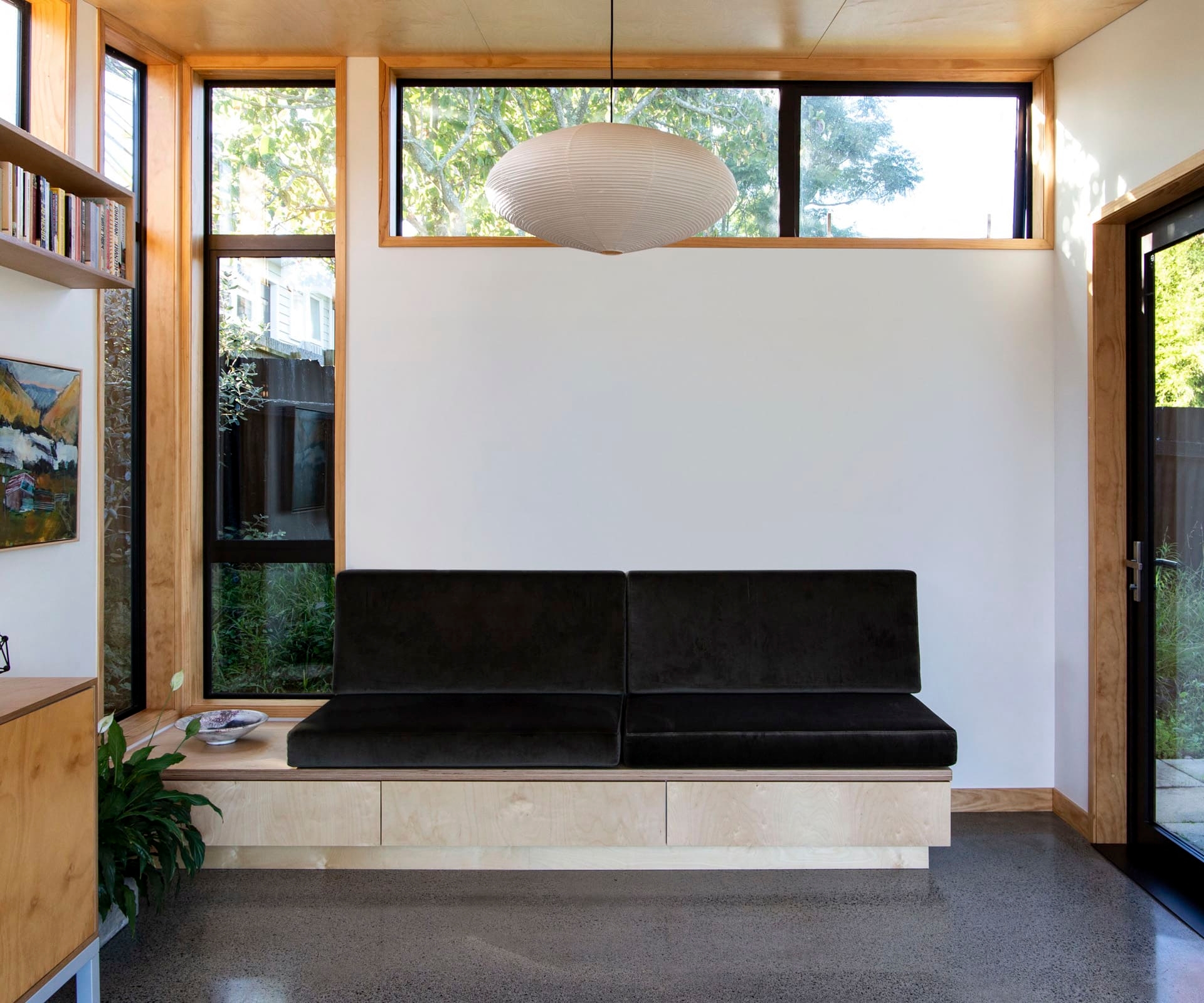 Entryway of the home with concrete floors and a floating seat