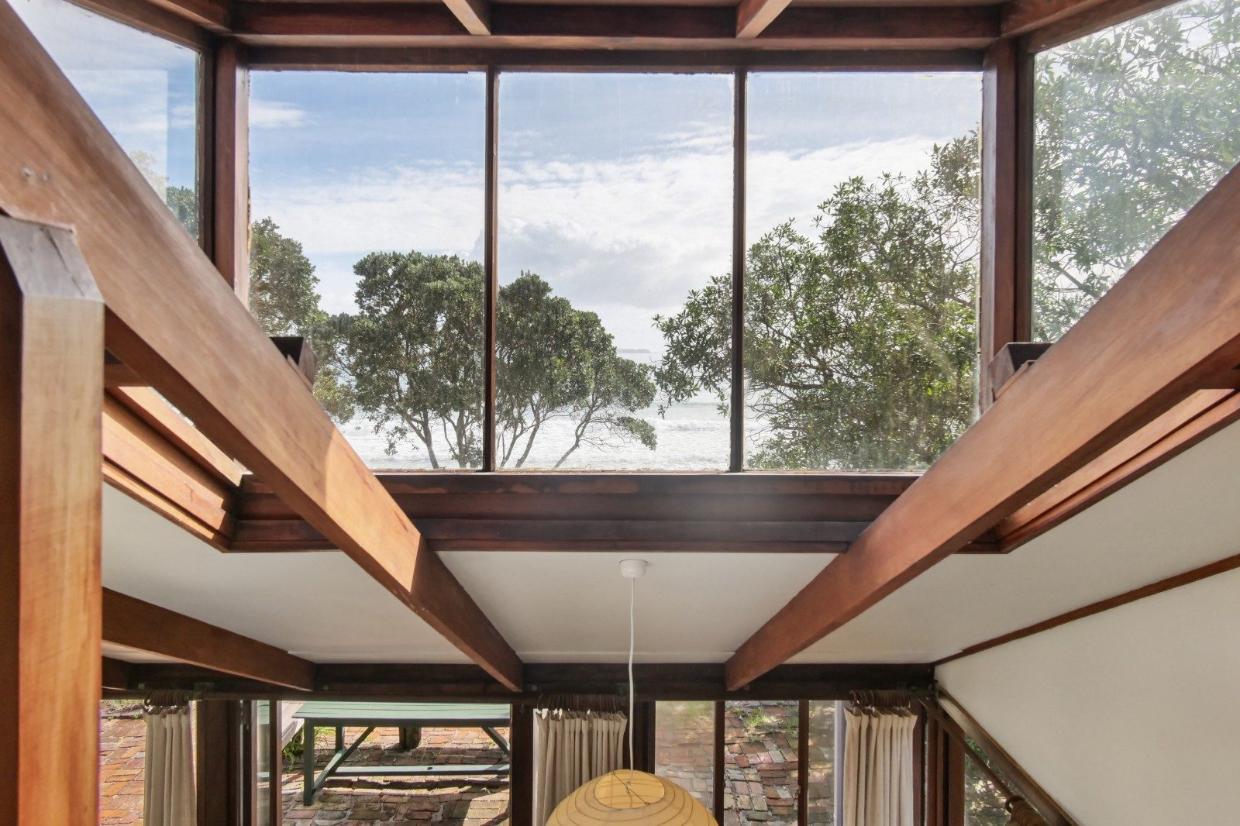 Large windows look out toward the ocean