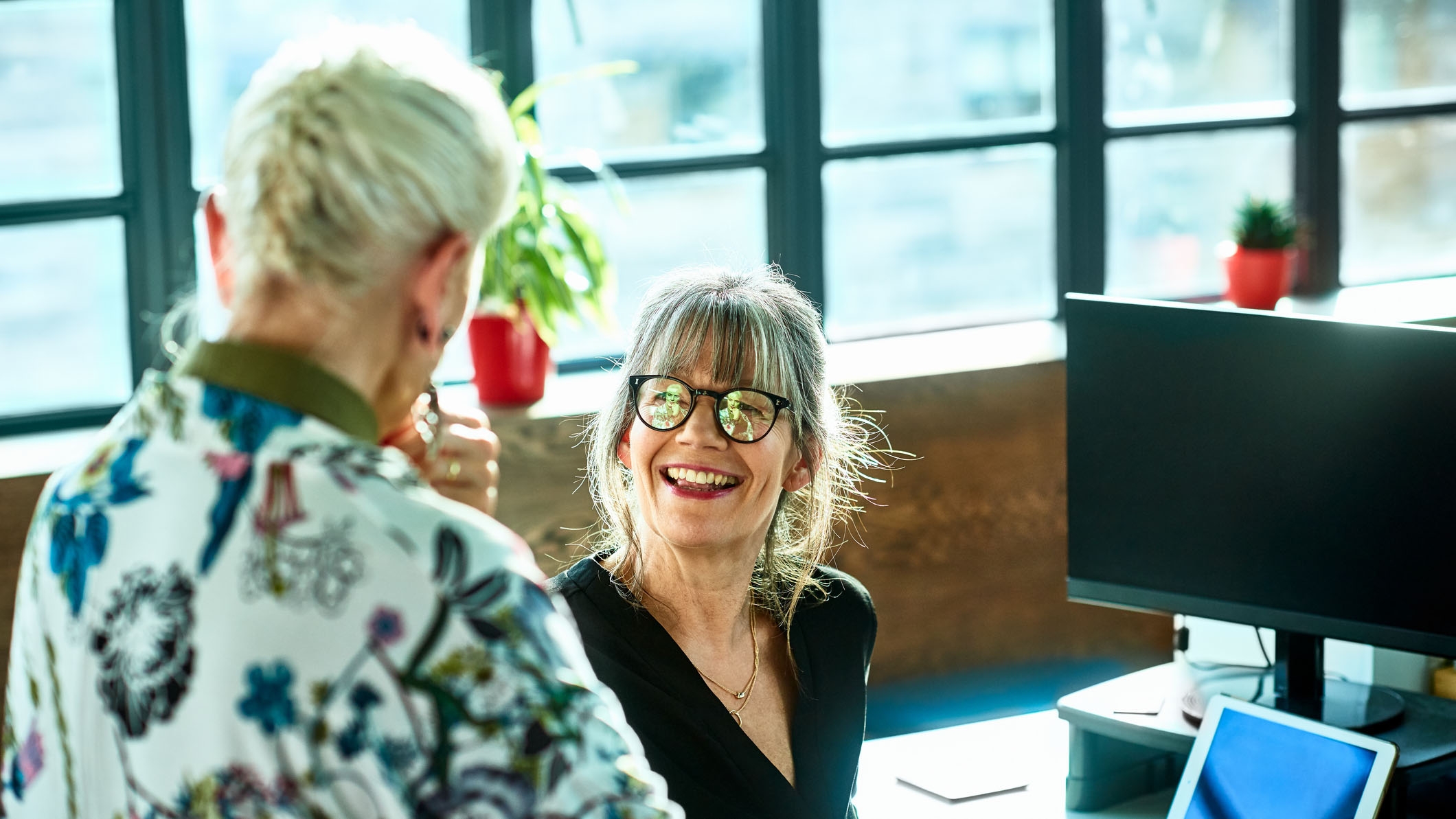 A woman asking her manager for a pay rise that reflects her changes in responsibility